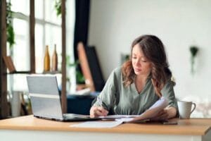 Female entrepreneur working from home on her side of the business.