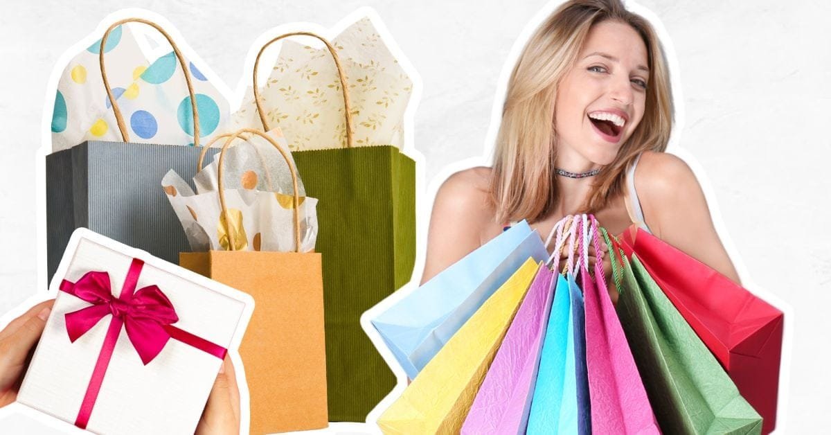 Woman with gift bags, more gift bags with gift wrap and a gift box.
